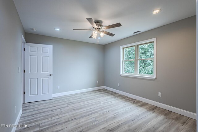 spare room featuring recessed lighting, baseboards, visible vents, and light wood-type flooring