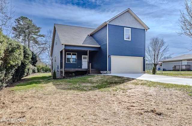 view of front of property with a front yard, a garage, and a porch