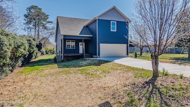 traditional home featuring a front yard, concrete driveway, an attached garage, and fence