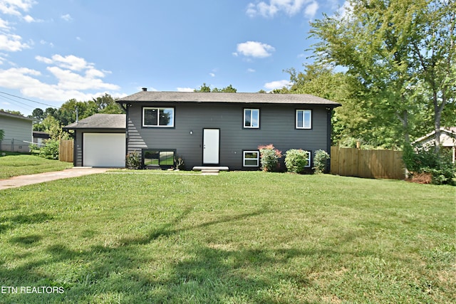 bi-level home featuring a garage and a front yard