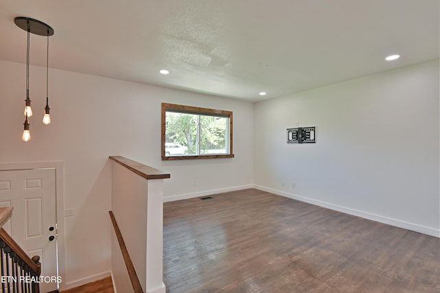 empty room with dark wood-type flooring