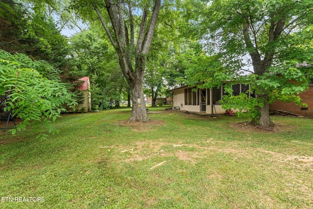 view of yard featuring a sunroom