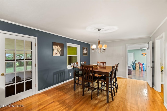 dining space featuring an inviting chandelier, crown molding, and hardwood / wood-style flooring