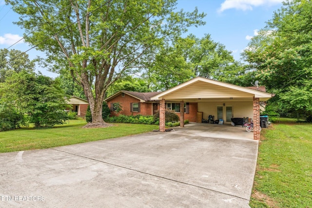 ranch-style house featuring a carport and a front lawn