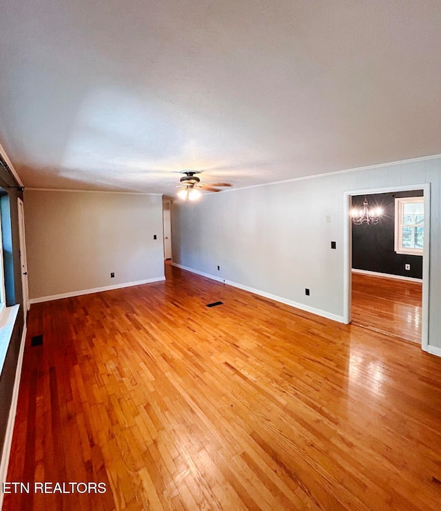 unfurnished room featuring ornamental molding, hardwood / wood-style floors, and ceiling fan