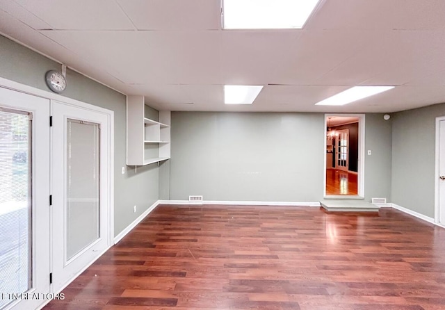 unfurnished room with dark wood-type flooring