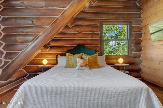 bedroom with hardwood / wood-style flooring and rustic walls