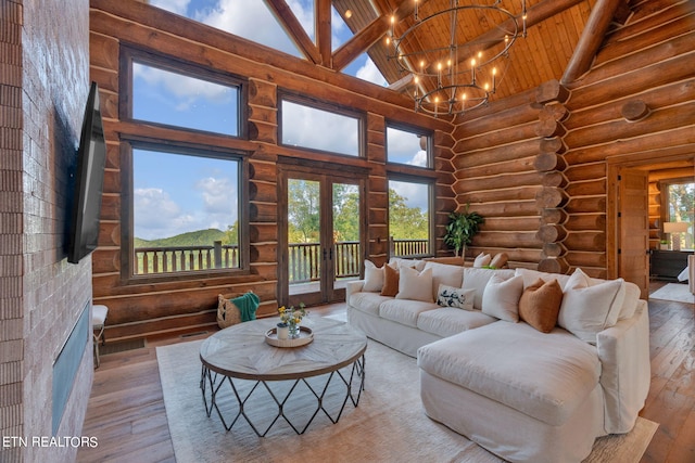 living room featuring wooden ceiling, high vaulted ceiling, light hardwood / wood-style flooring, and rustic walls