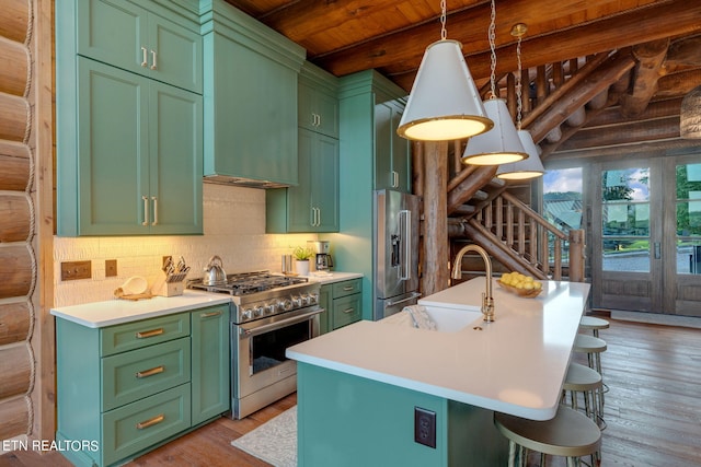 kitchen with a kitchen island with sink, beam ceiling, light hardwood / wood-style floors, and premium appliances