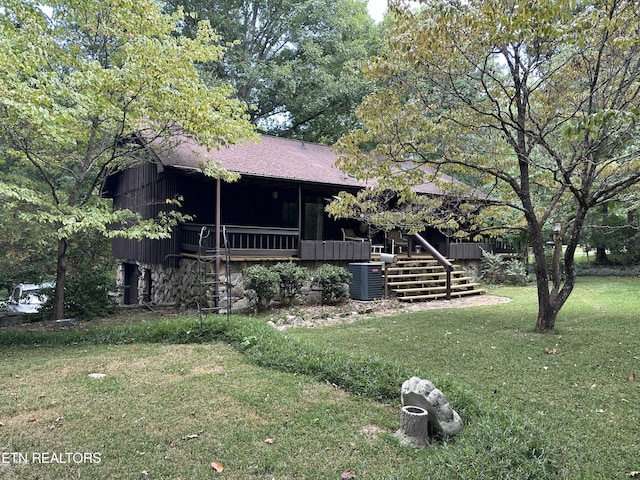 exterior space featuring central AC and a front yard