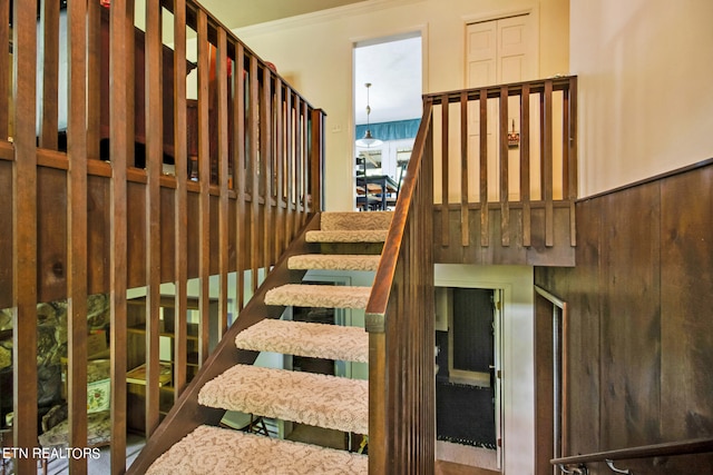 stairs featuring crown molding