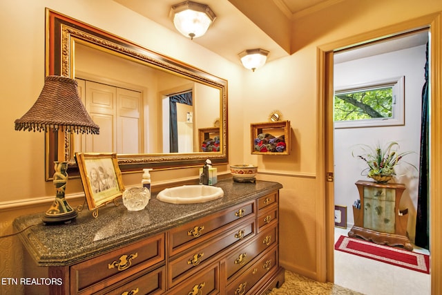 bathroom featuring ornamental molding and vanity