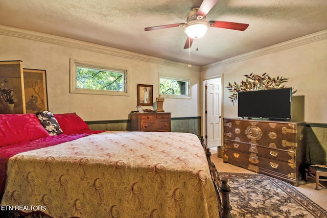 bedroom featuring carpet floors, crown molding, and a textured ceiling