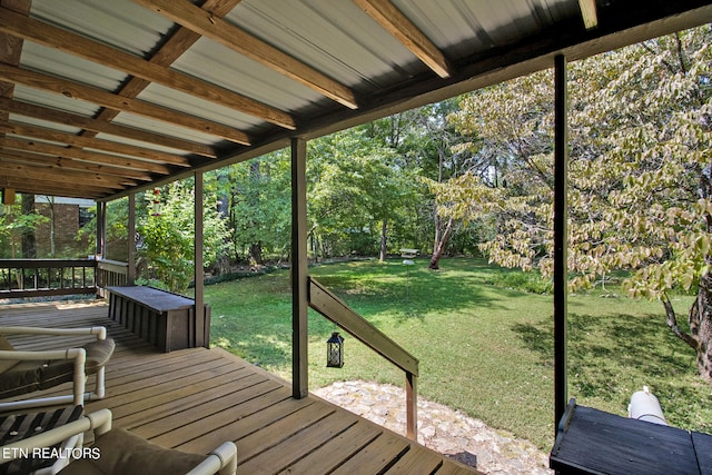 wooden terrace featuring a lawn