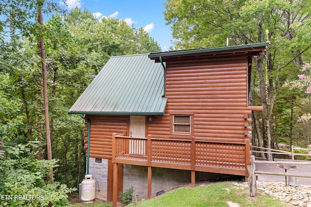 view of side of property featuring a wooden deck