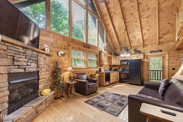 living room featuring a fireplace, light wood-type flooring, wood walls, and high vaulted ceiling