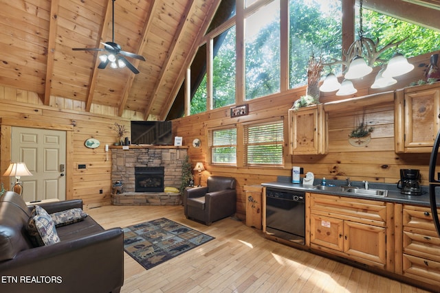 kitchen featuring light wood-type flooring, a fireplace, high vaulted ceiling, and dishwasher