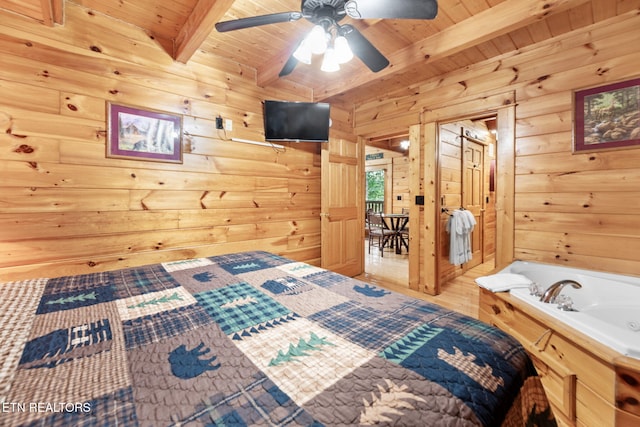 bedroom featuring beamed ceiling, hardwood / wood-style flooring, ceiling fan, a barn door, and wood ceiling