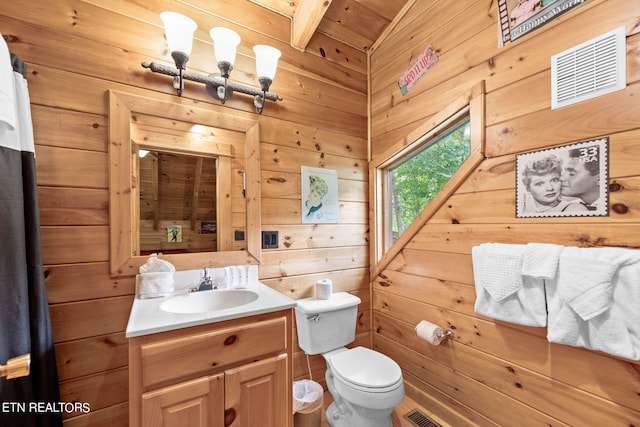 bathroom with wood walls, vanity, wooden ceiling, and toilet