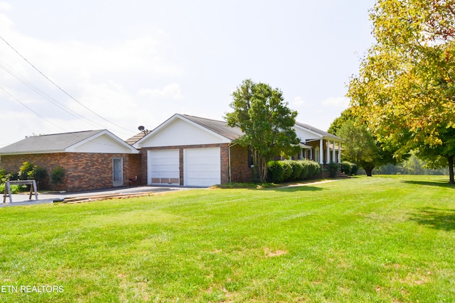 ranch-style home featuring a garage and a front lawn