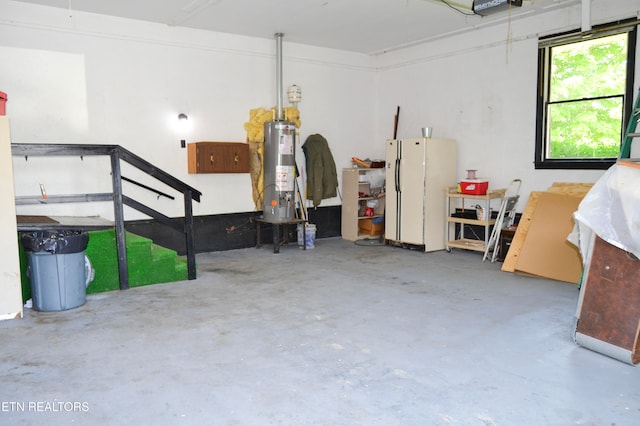 garage with gas water heater and white fridge