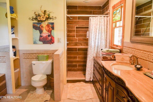 bathroom with tile patterned flooring, a shower with curtain, vanity, and toilet