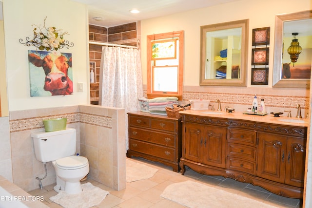 bathroom featuring vanity, tasteful backsplash, tile patterned floors, tile walls, and toilet