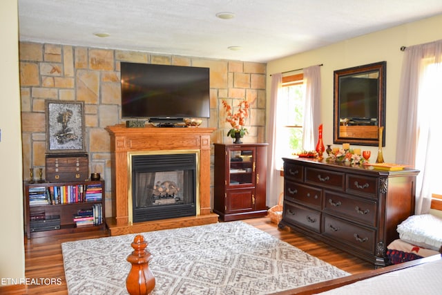 living room with a textured ceiling and dark hardwood / wood-style flooring