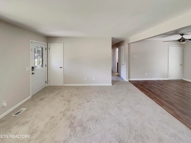 entrance foyer featuring carpet and ceiling fan