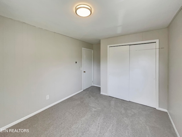 unfurnished bedroom with a closet and carpet