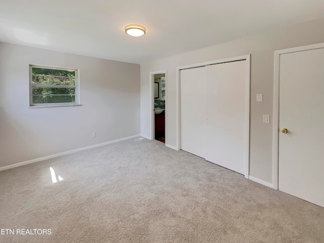 unfurnished bedroom with light colored carpet