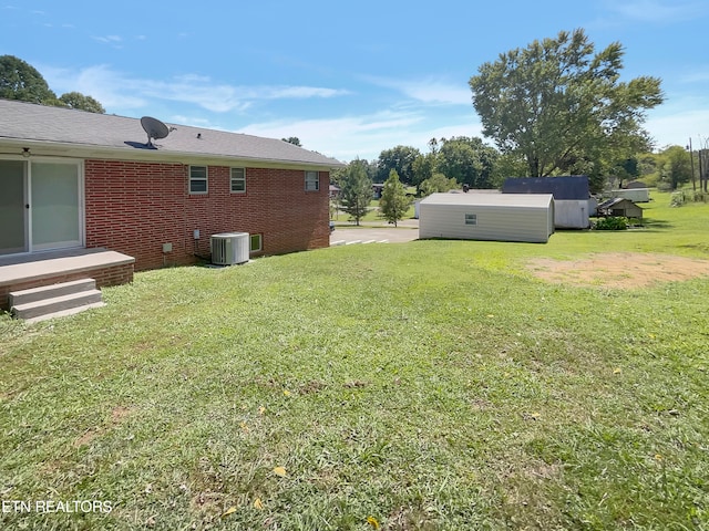 view of yard with an outdoor structure and central AC