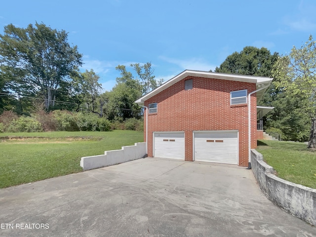 view of home's exterior featuring a lawn and a garage