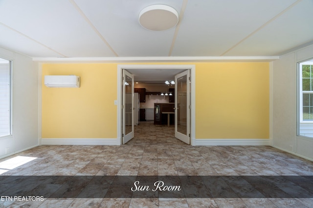 empty room with an AC wall unit and tile patterned floors