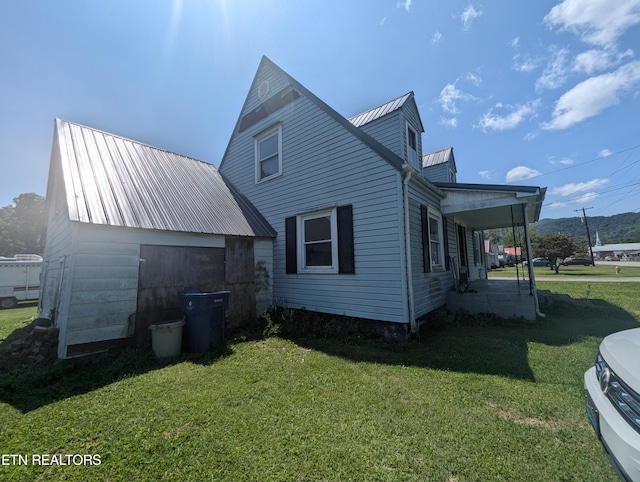 rear view of property featuring a yard