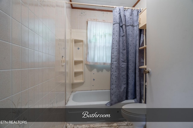 bathroom with shower / bath combination with curtain and toilet