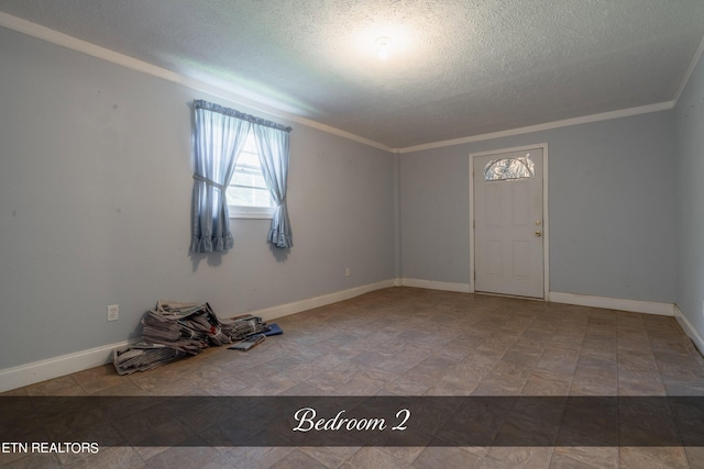 interior space featuring a textured ceiling and crown molding