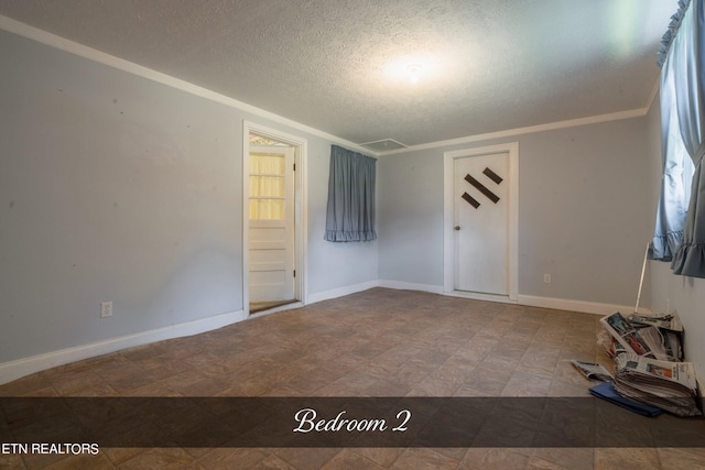 interior space with a textured ceiling and ornamental molding