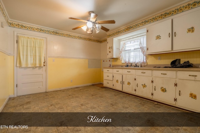 kitchen featuring ceiling fan, ornamental molding, tile patterned flooring, and white cabinetry