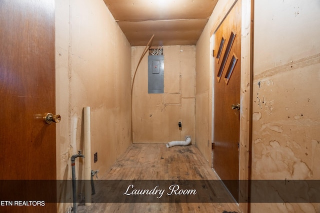 bathroom featuring electric panel and hardwood / wood-style flooring