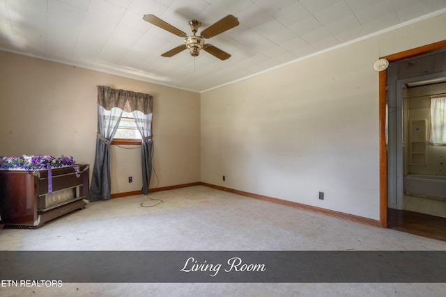 empty room featuring ceiling fan and ornamental molding