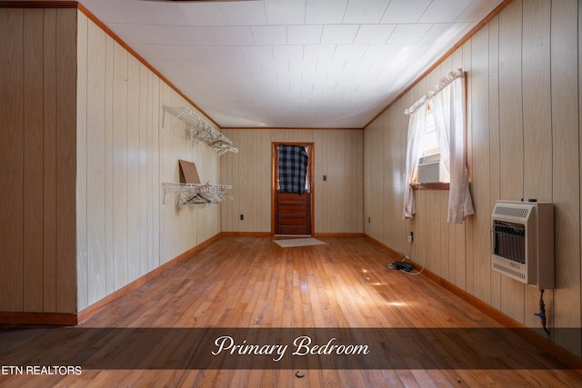 foyer entrance featuring wooden walls, light hardwood / wood-style floors, and ornamental molding