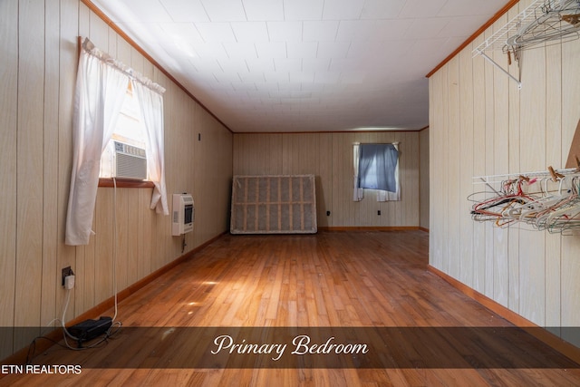 additional living space featuring wood walls, cooling unit, and wood-type flooring