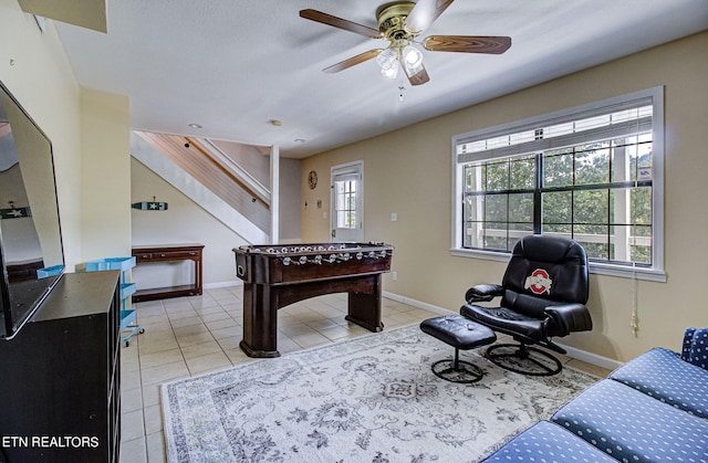 game room with a wealth of natural light, ceiling fan, and light tile patterned flooring