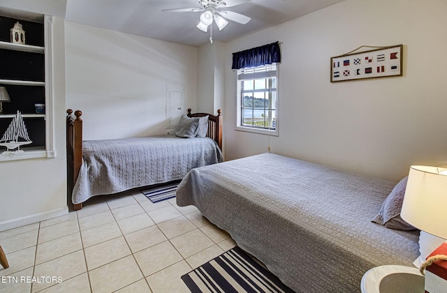 tiled bedroom featuring ceiling fan