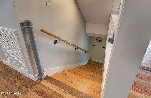 stairway with hardwood / wood-style flooring