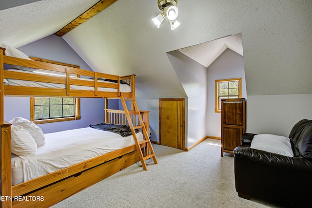 carpeted bedroom featuring vaulted ceiling and a textured ceiling