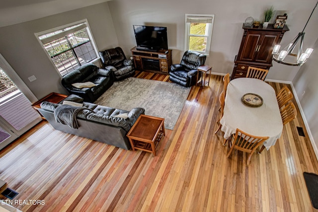 living room featuring a chandelier and hardwood / wood-style flooring