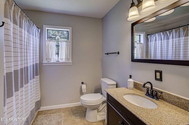 bathroom with tile patterned floors, vanity, walk in shower, and toilet