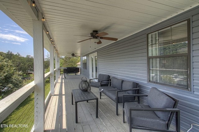 wooden terrace featuring ceiling fan and an outdoor hangout area